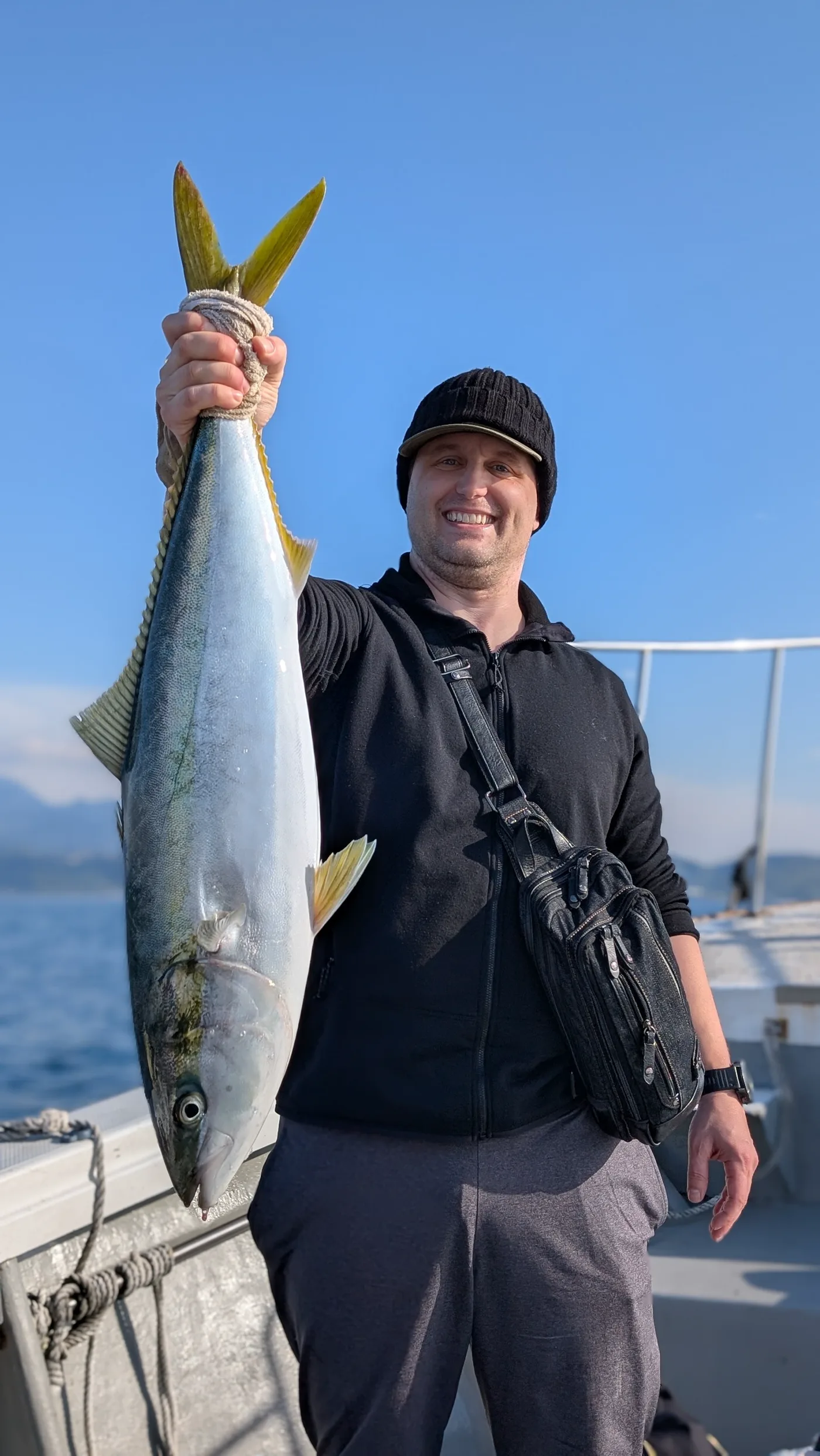 Dr. Baker holding a large yellowtail off the coast of Japan